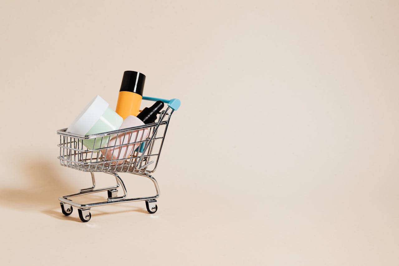 why-choose-us A minimalist image of a mini shopping cart filled with cosmetics on a beige background, ideal for e-commerce concepts.